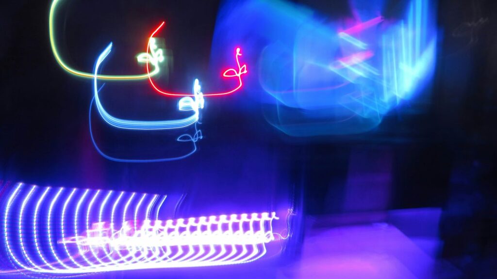 a blurry photo of a building with neon lights