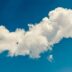 a white cloud floating in a blue sky