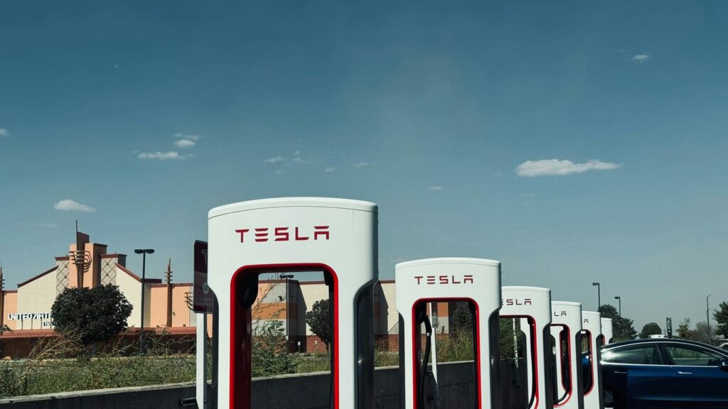 a row of tesla electric cars parked next to each other
