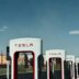 a row of tesla electric cars parked next to each other