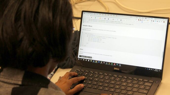 a person sitting in front of a laptop computer