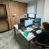 People work at desks in a modern office.
