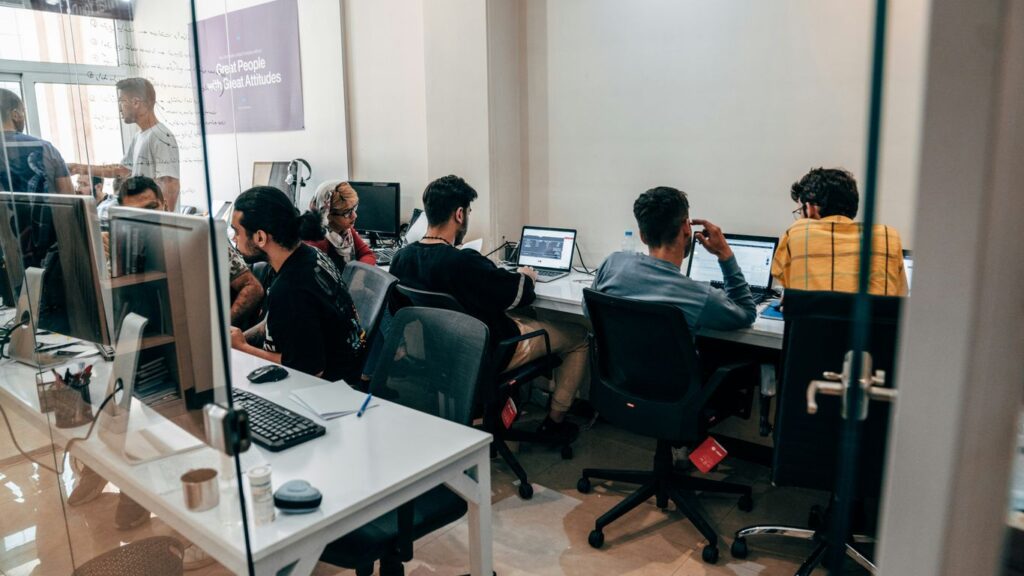 a group of people sitting at computers