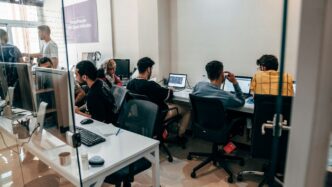 a group of people sitting at computers