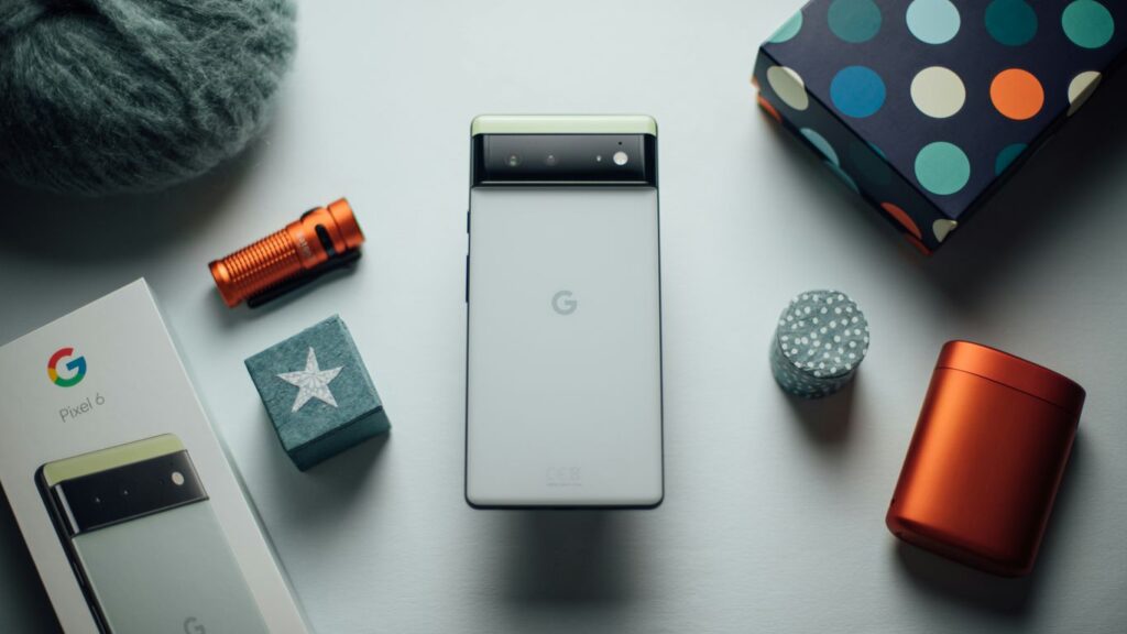 a cell phone sitting on top of a table next to other items