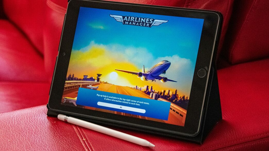 a tablet sitting on top of a red couch