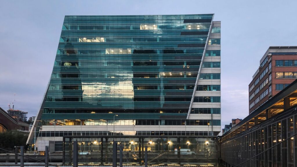 A very tall building sitting next to a bridge