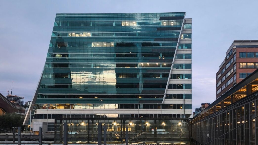 A very tall building sitting next to a bridge