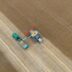 Tractor and seeder working in a harvested wheat field.