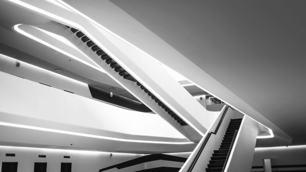 a black and white photo of an escalator