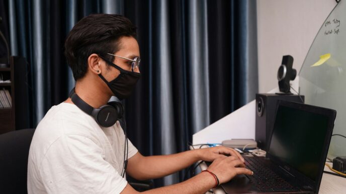 man in white crew neck t-shirt using black laptop computer