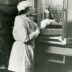 a black and white photo of a woman in a lab