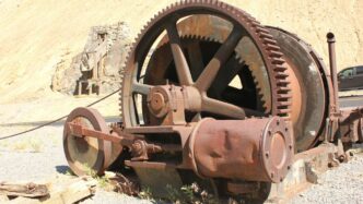 a rusted wheel on a wall