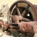 a rusted wheel on a wall