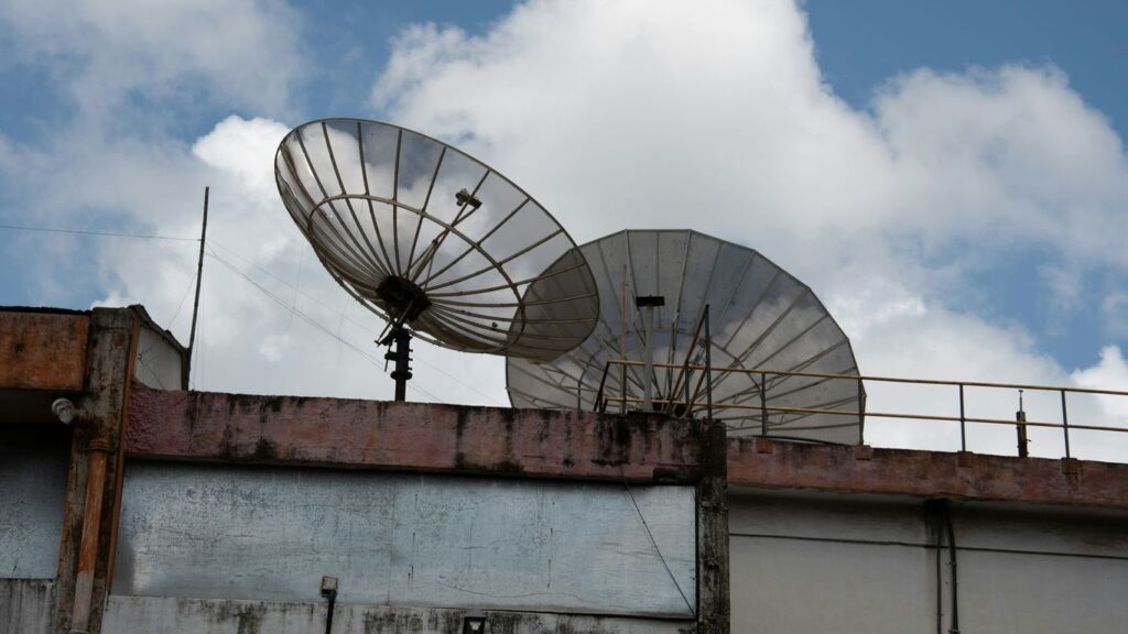 a couple of satellite dishes sitting on top of a building