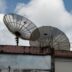 a couple of satellite dishes sitting on top of a building