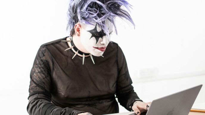 a person in a mask using a laptop