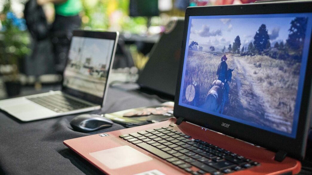 a couple of laptops sit on a table