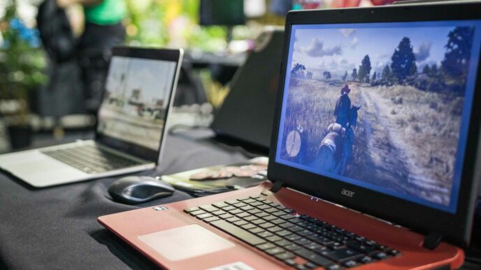 a couple of laptops sit on a table