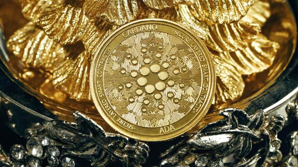 a gold coin sitting on top of a pile of silver chains