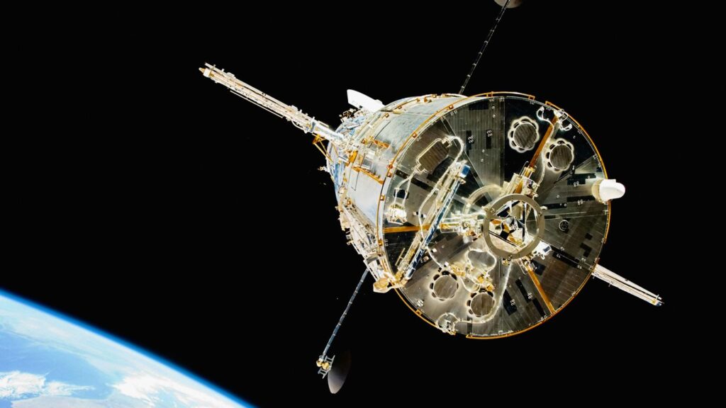 a satellite in orbit with the earth in the background