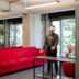 a man standing in a room with a red couch
