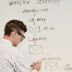 man writing on whiteboard