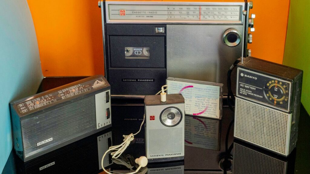 a bunch of old radio's sitting on a table
