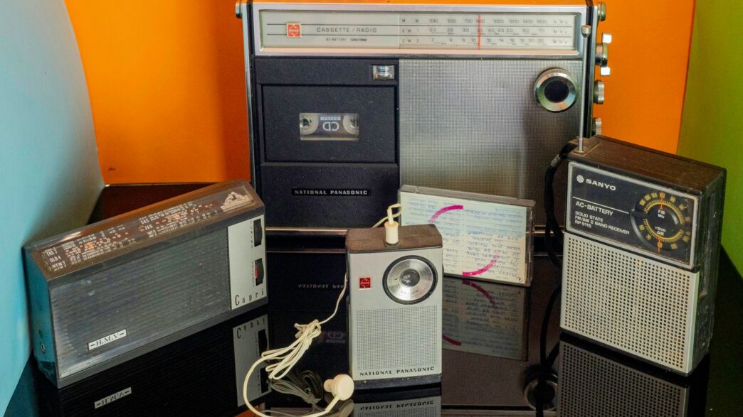 a bunch of old radio's sitting on a table