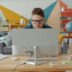 Man working on computer in colorful home office