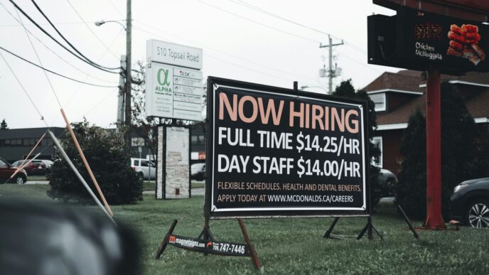 a sign in the grass advertising a job fair