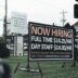 a sign in the grass advertising a job fair