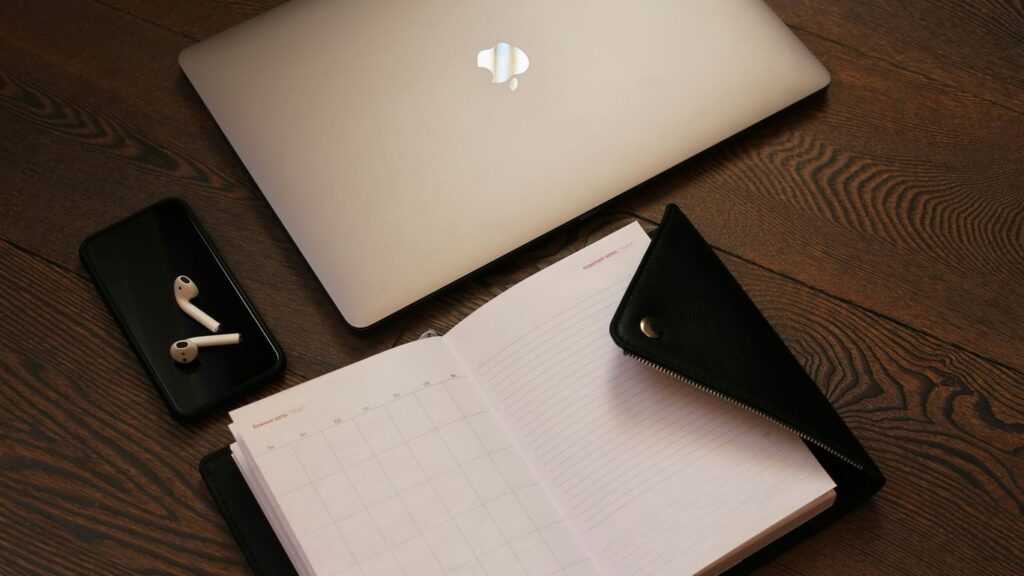 silver macbook beside black iphone 5