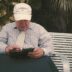 a man sitting on a bench looking at his cell phone