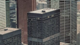 a view of some very tall buildings in a big city