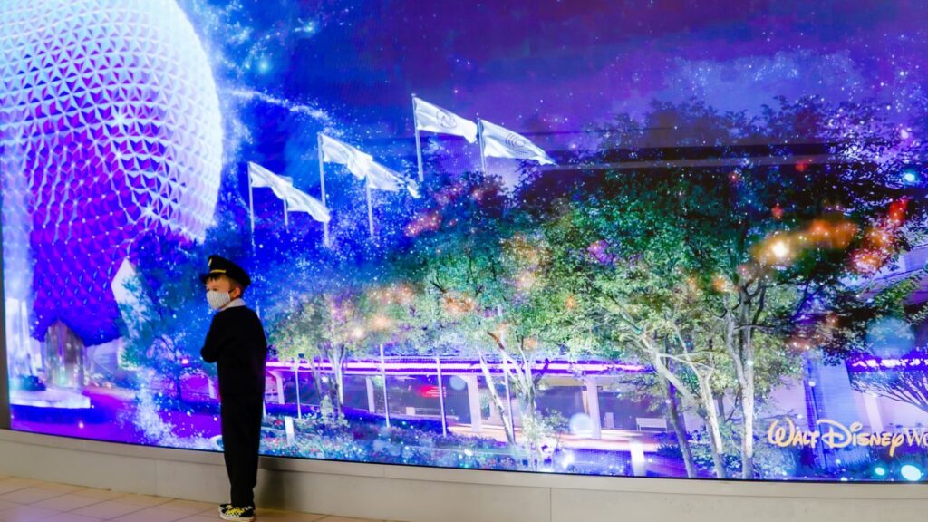 a man standing in front of a wall with lights