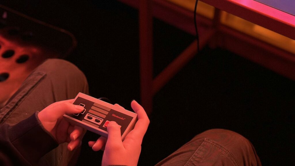 a person sitting on the floor playing a video game
