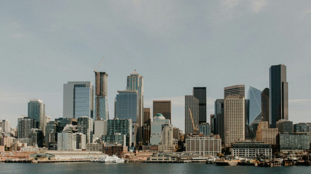 city skyline across body of water during daytime