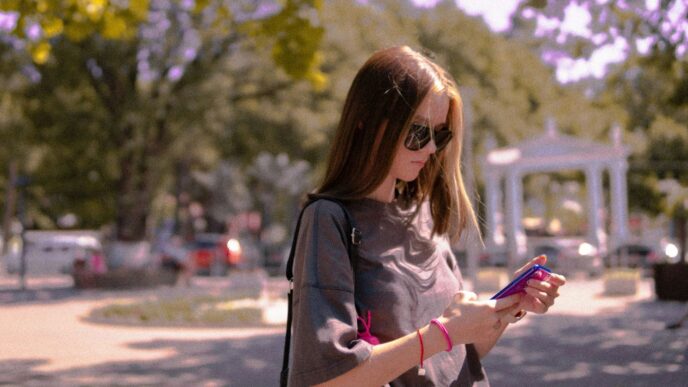 woman in black leather jacket holding smartphone
