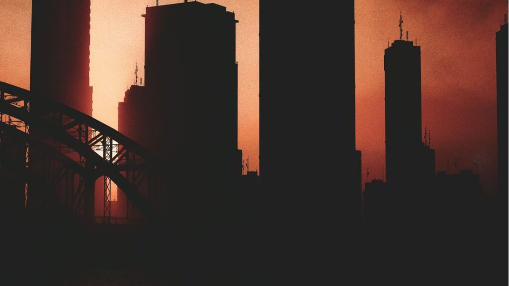 a picture of a city skyline with a bridge in the foreground