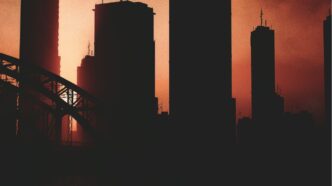 a picture of a city skyline with a bridge in the foreground