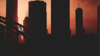 a picture of a city skyline with a bridge in the foreground