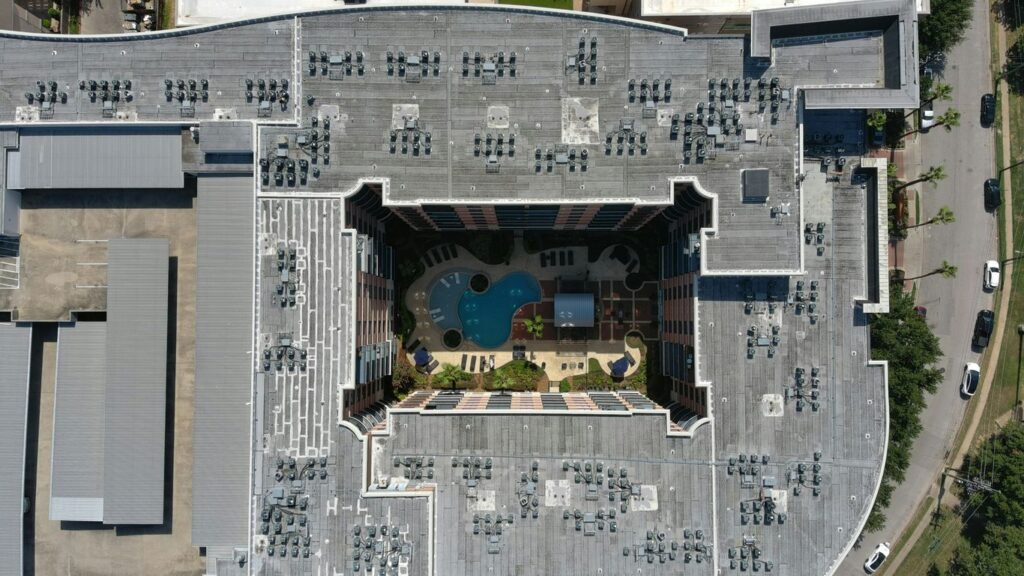 an aerial view of a building with a swimming pool