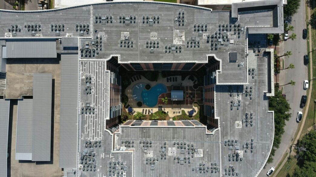 an aerial view of a building with a swimming pool