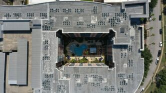 an aerial view of a building with a swimming pool