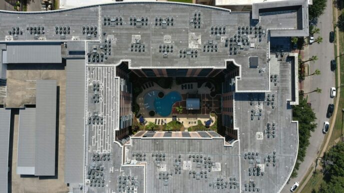 an aerial view of a building with a swimming pool