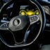 a car dashboard with a steering wheel and dashboard lights