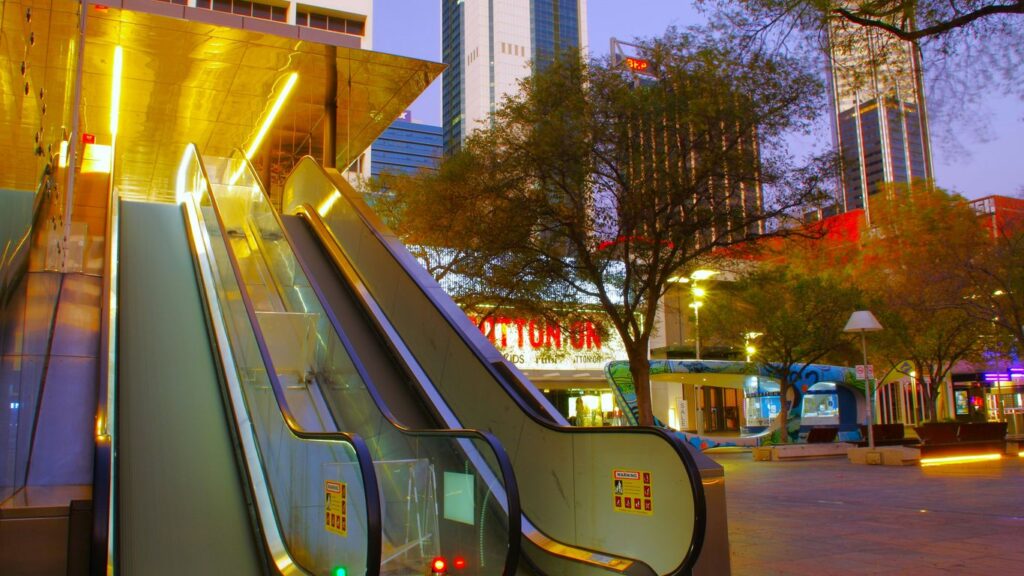 An escalator with a building in the background