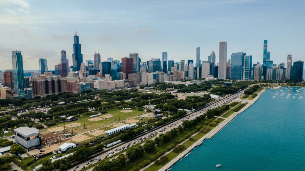 a city skyline with a body of water in front of it