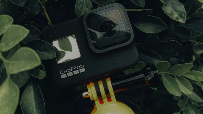 a camera sitting on top of a yellow fire hydrant